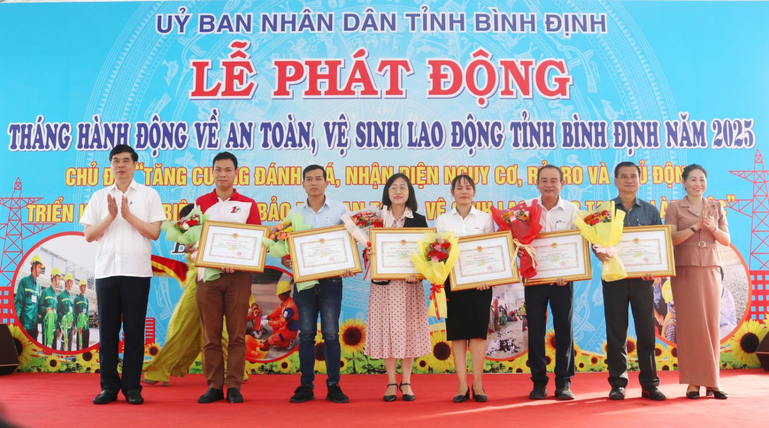 Phó Chủ tịch UBND tỉnh Lâm Hải Giang (bìa trái) trao Bằng khen và Phó Chủ tịch HĐND tỉnh Huỳnh Thúy Vân (bìa phải) tặng hoa cho các tập thể.